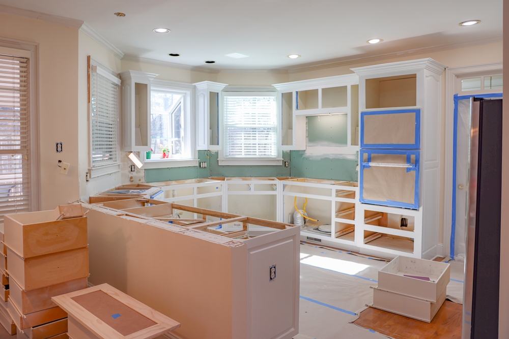 Kitchen renovation in progress showing white cabinet installation and countertop prep work by Black Ridge Contracting in Ankeny Iowa